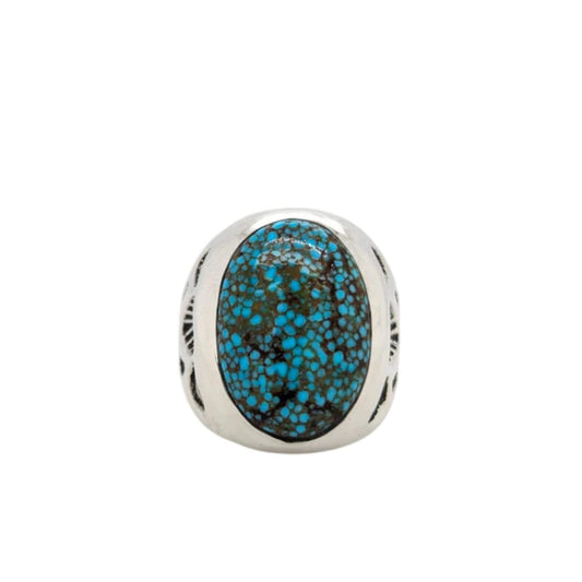 Southwestern sterling silver ring featuring an oval Kingman turquoise stone with black matrix and hand-carved sterling silver details on the band.