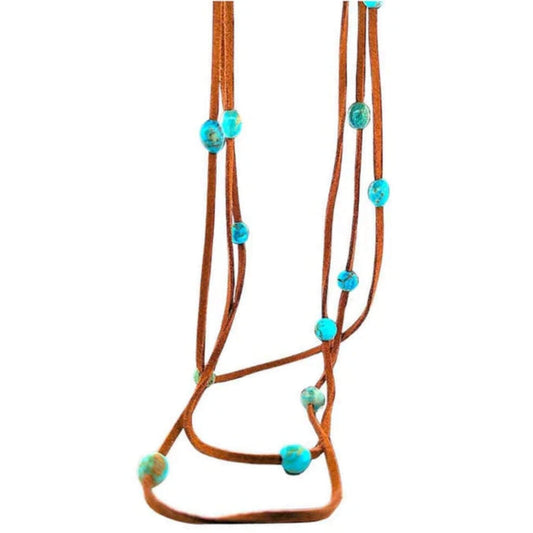 Delicate Southwestern necklace featuring layered leather cords and vibrant Kingman turquoise beads with blue and green hues.