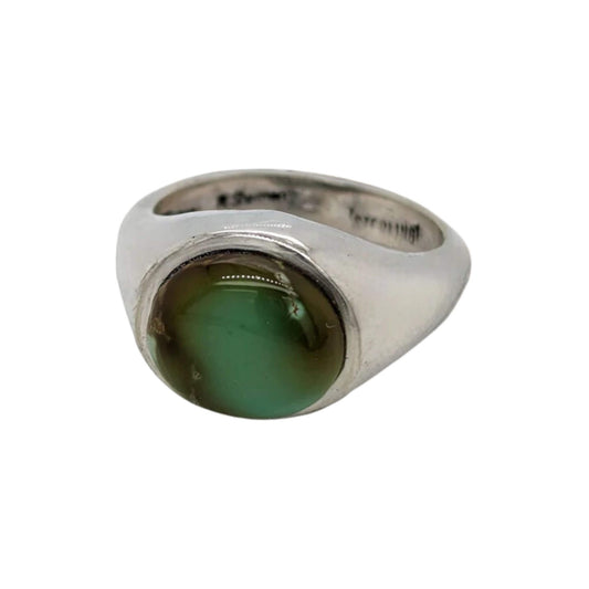 Oval green turquoise ring in a sterling silver setting, showcasing the natural beauty of the gemstone.