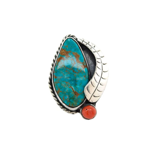 Statement ring featuring a leaf-shaped American turquoise stone in a carved sterling silver frame with a small, round coral accent.